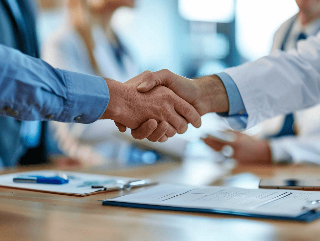 A handshake with a construction plan in the background.
