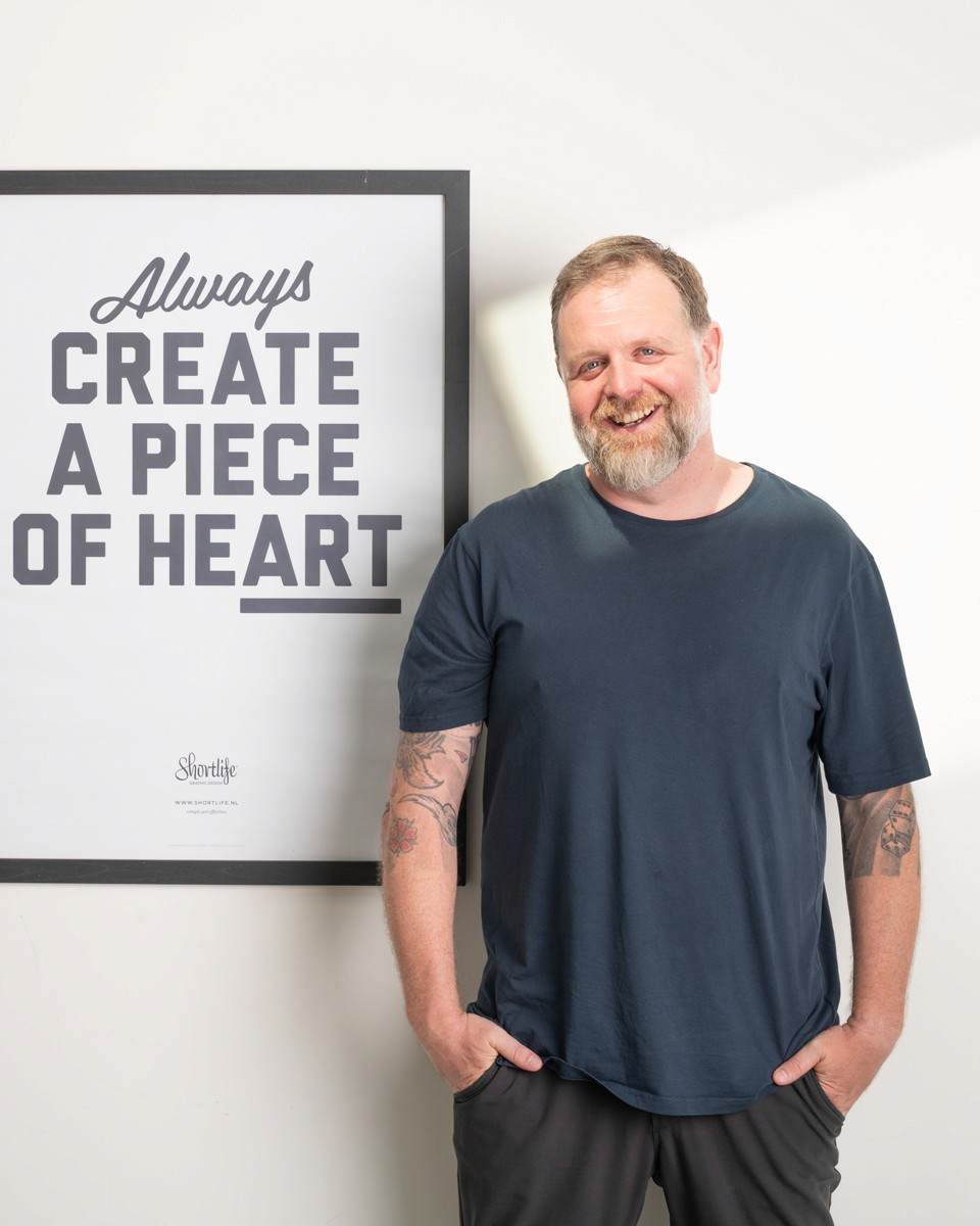 Abstract swirling patterns of teal, dark blue, and hints of orange, resembling a fluid cosmic design.