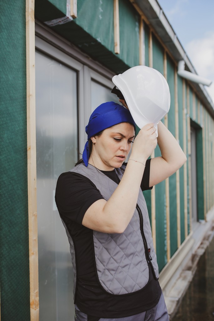 Black G-Heat cooling cap worn by a man on a construction site with a cooling vest