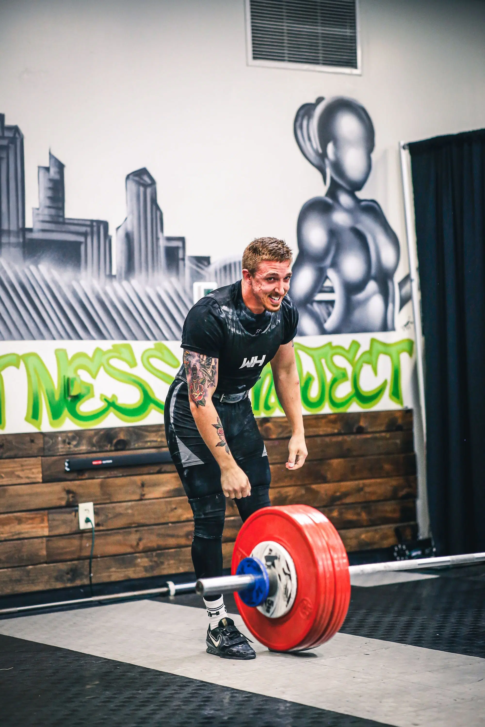 Man powerlifting smiling