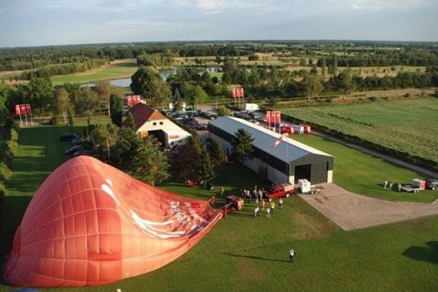 A balloon being readied on a farm field, seen from above