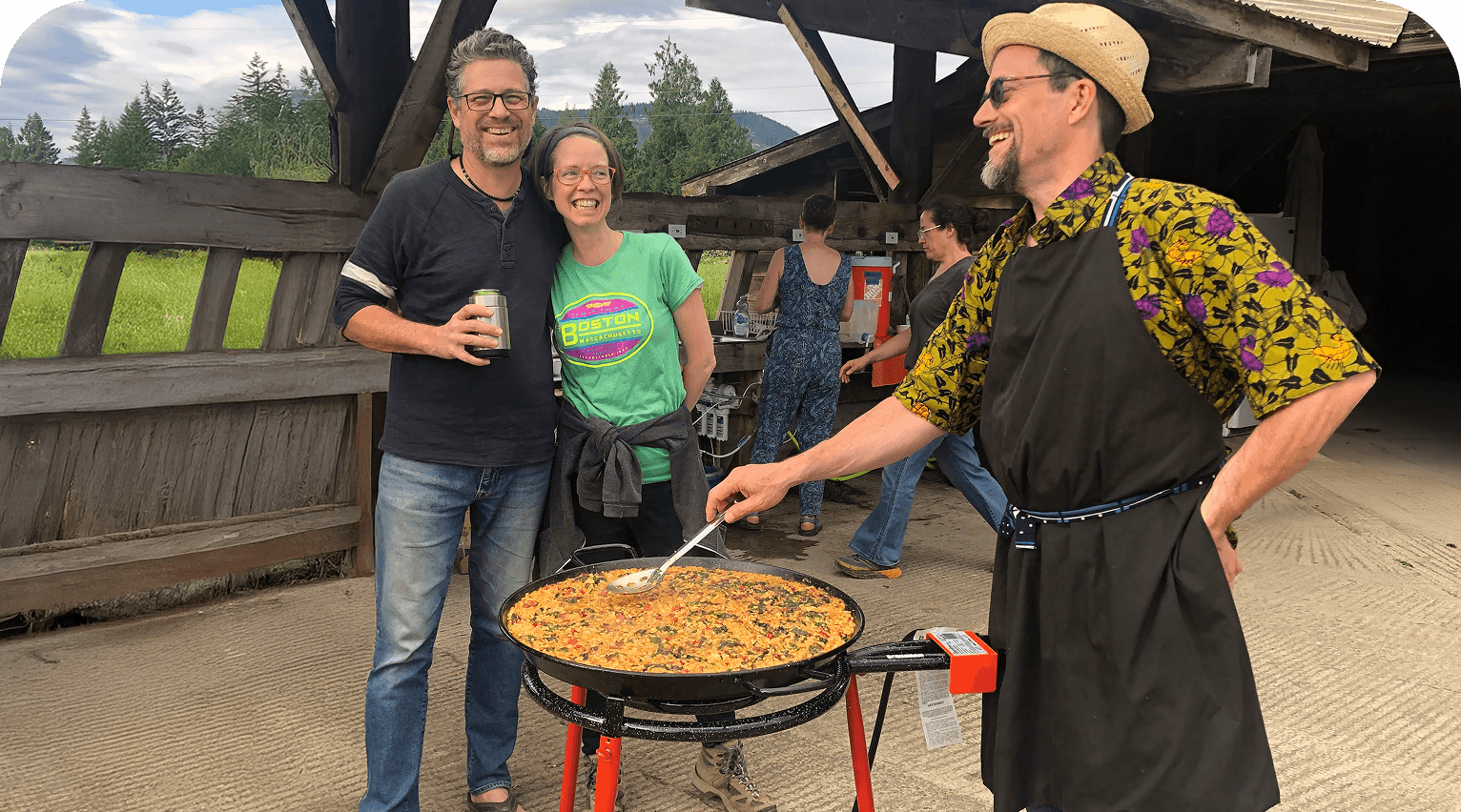 Rows of crops growing under protective covers on a working farm.