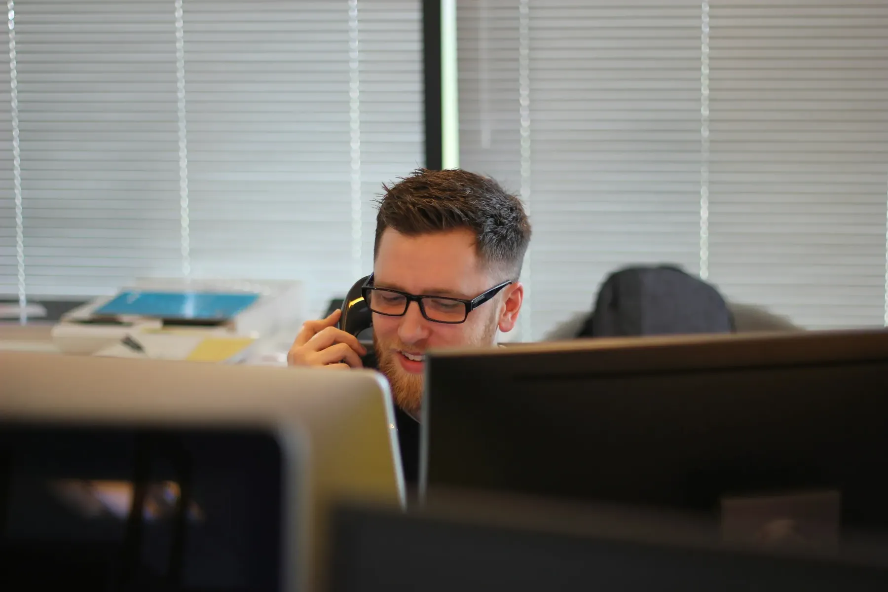 Mann im Büro telefoniert am Arbeitsplatz steht für persönlichen Kundenkontakt und Serviceintegration mit mercury.ai