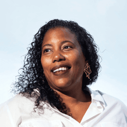 Possible member smiling and looking away from the camera.