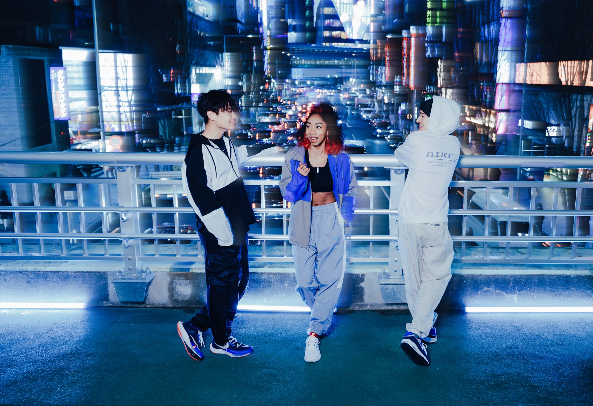3 people on top of a bridge