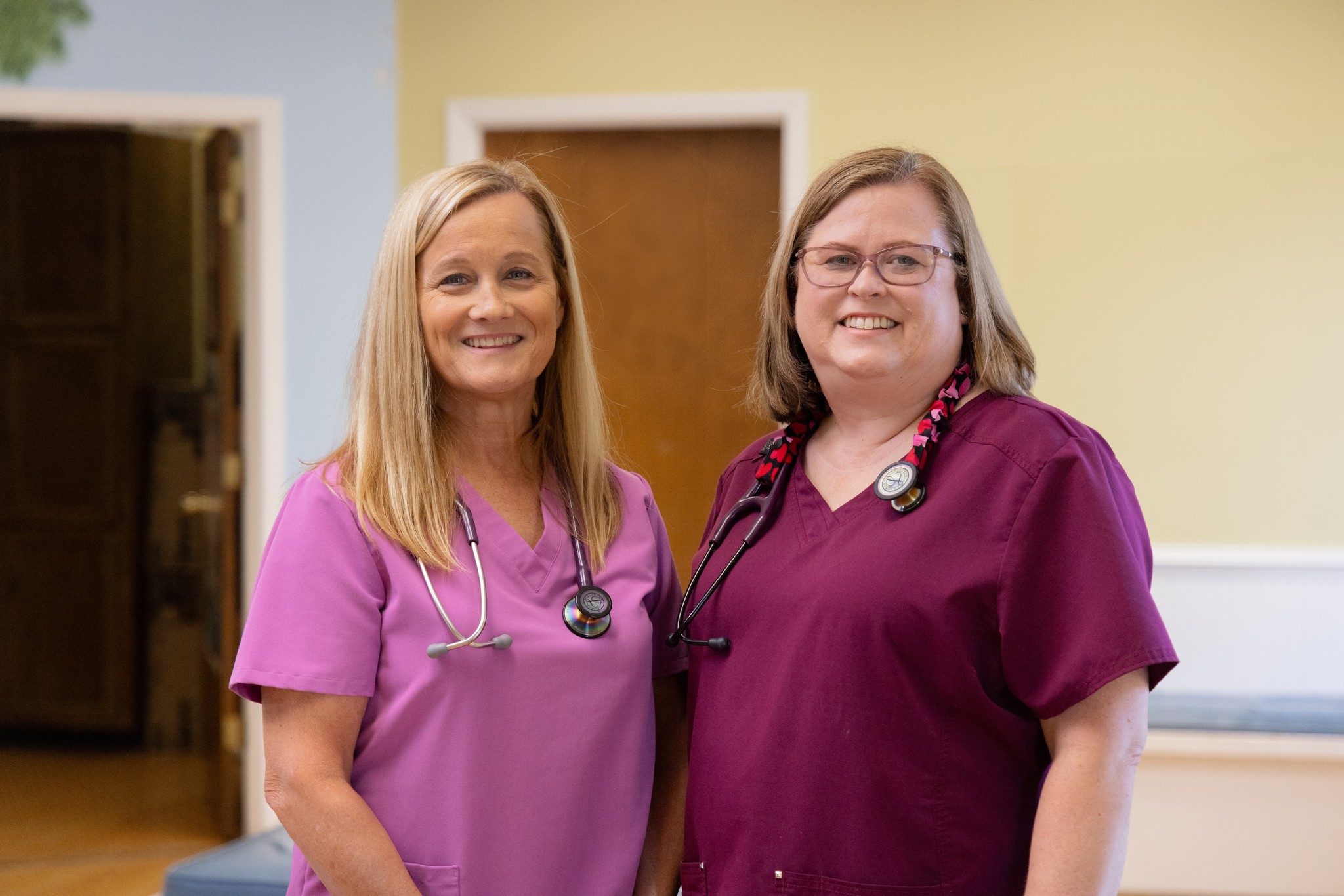 Two Nurse Practitioners smiling.