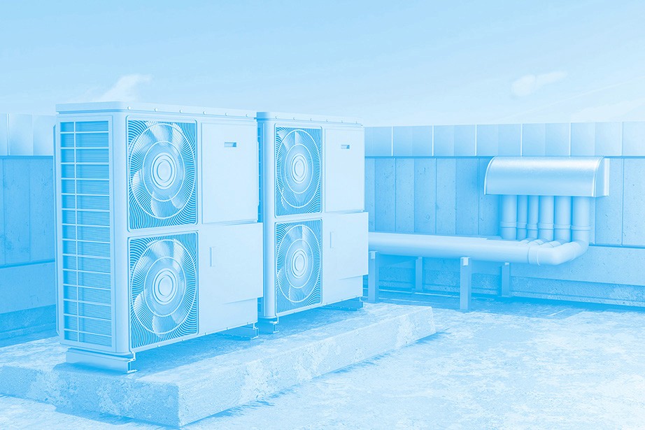 A blue-toned image of a rooftop air conditioning setup, featuring multiple units with fans, connected by ducts.