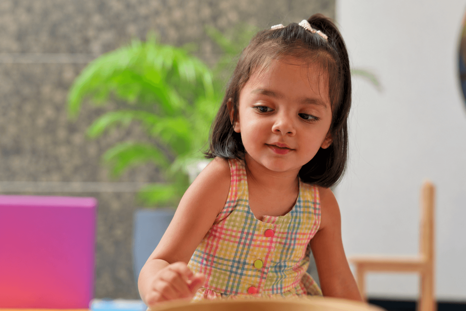 Smiling baby inside a kindergardent enviornment