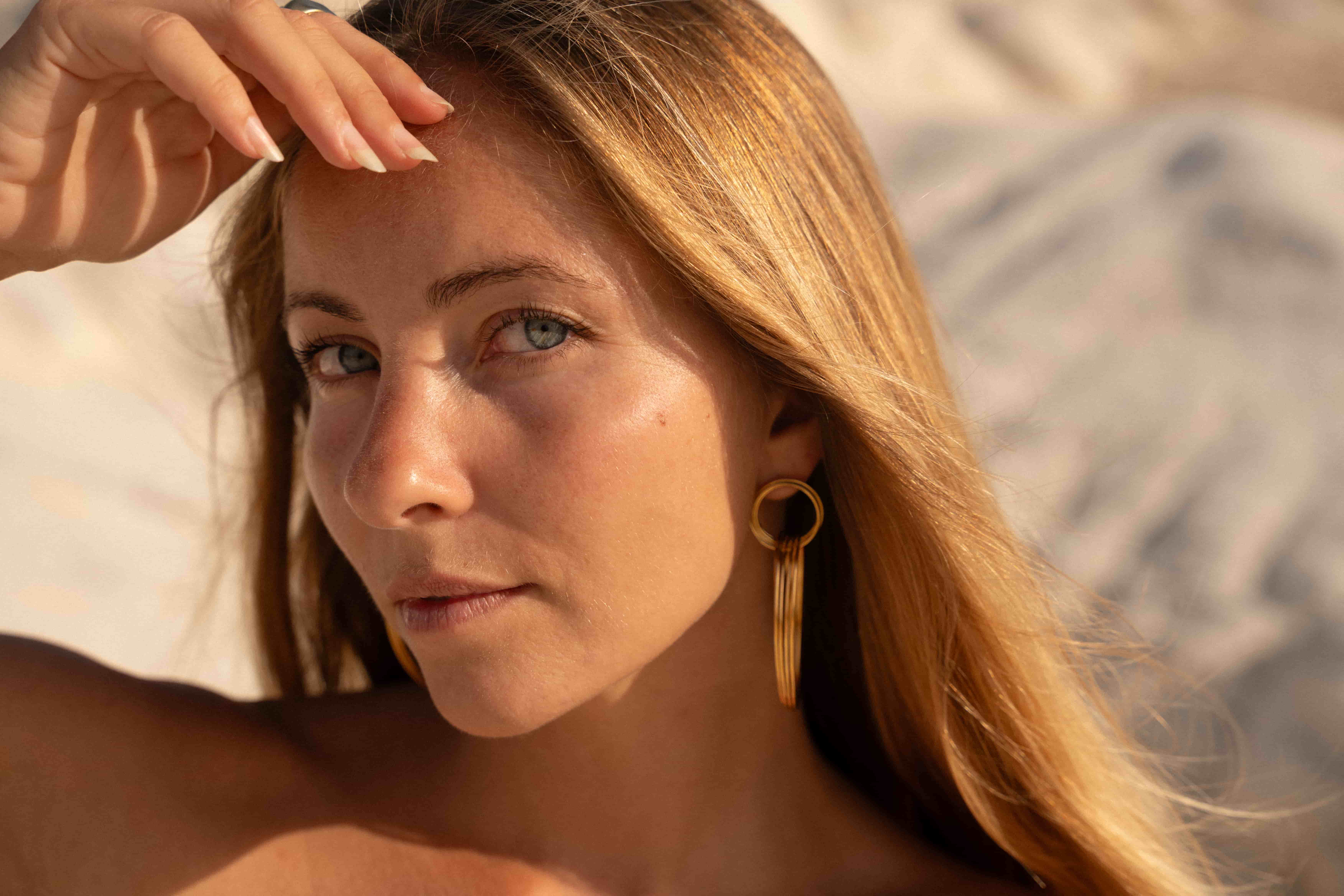 Portrait of a woman wearing handcrafted jewelry at sunset