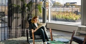 Parcom Office woman seating in a building behind the window