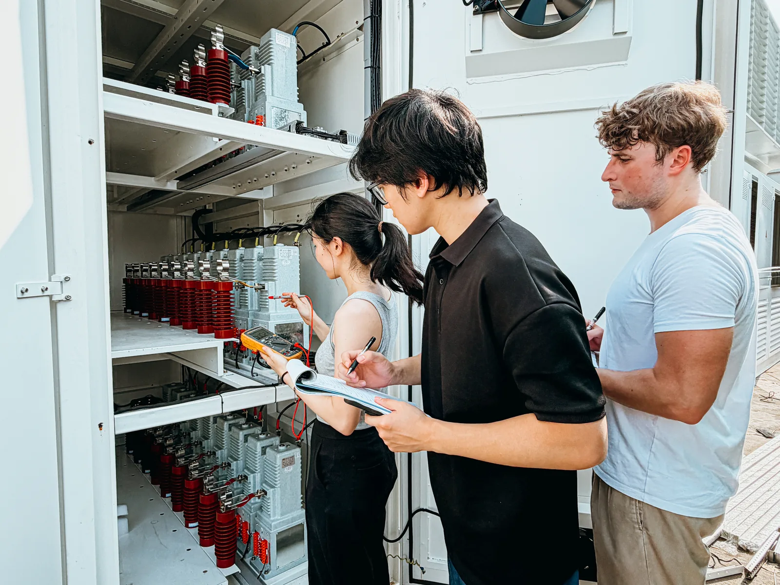 Three members of the team checking and logging medium voltage switchgear on site