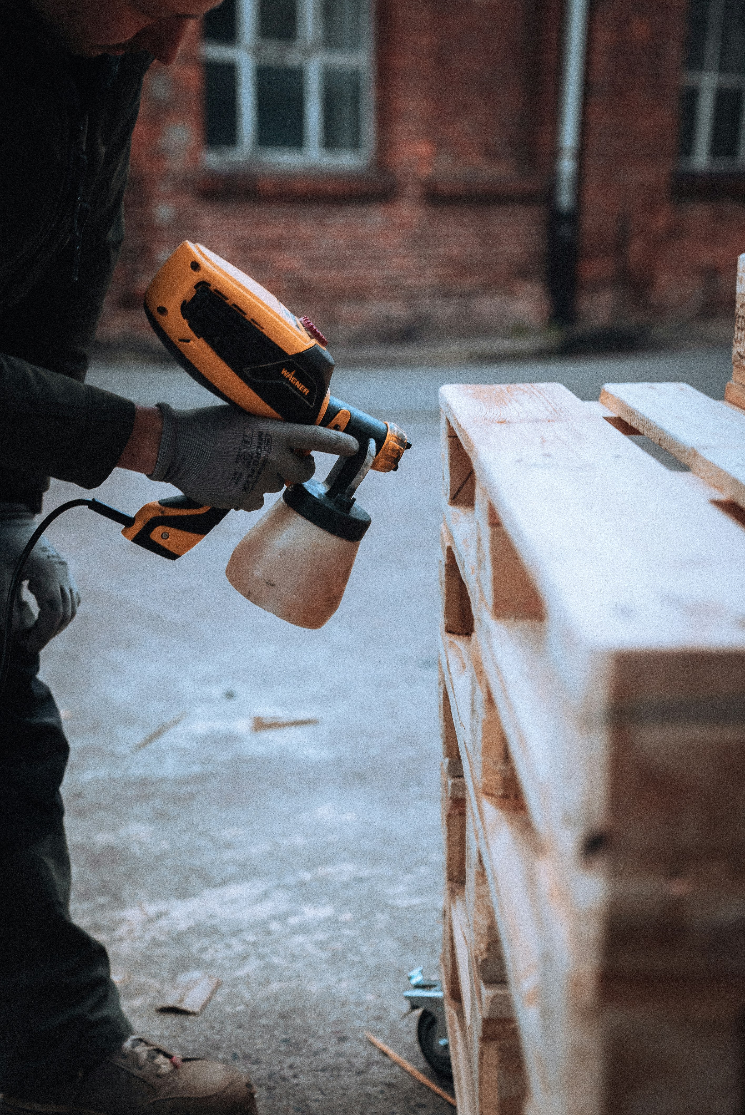 a man using a drill gun on a piece of wood