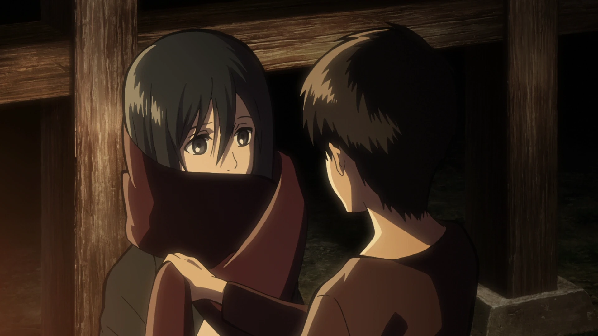 Eren wraps his red scarf around Mikasa