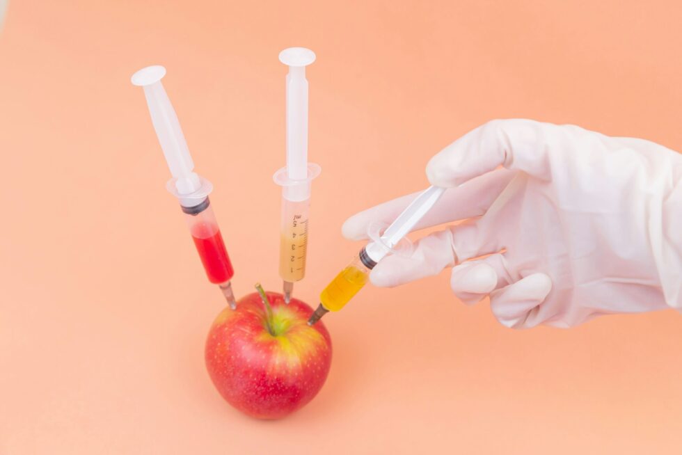 Image of an apple being injected with vaccines