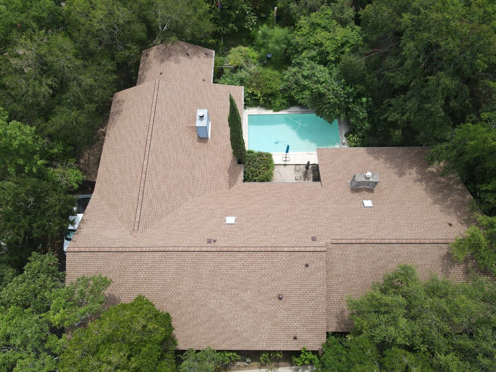 Large cross-hipped roof with two chimneys and skylights, featuring a GAF Cobra vent for enhanced attic ventilation.