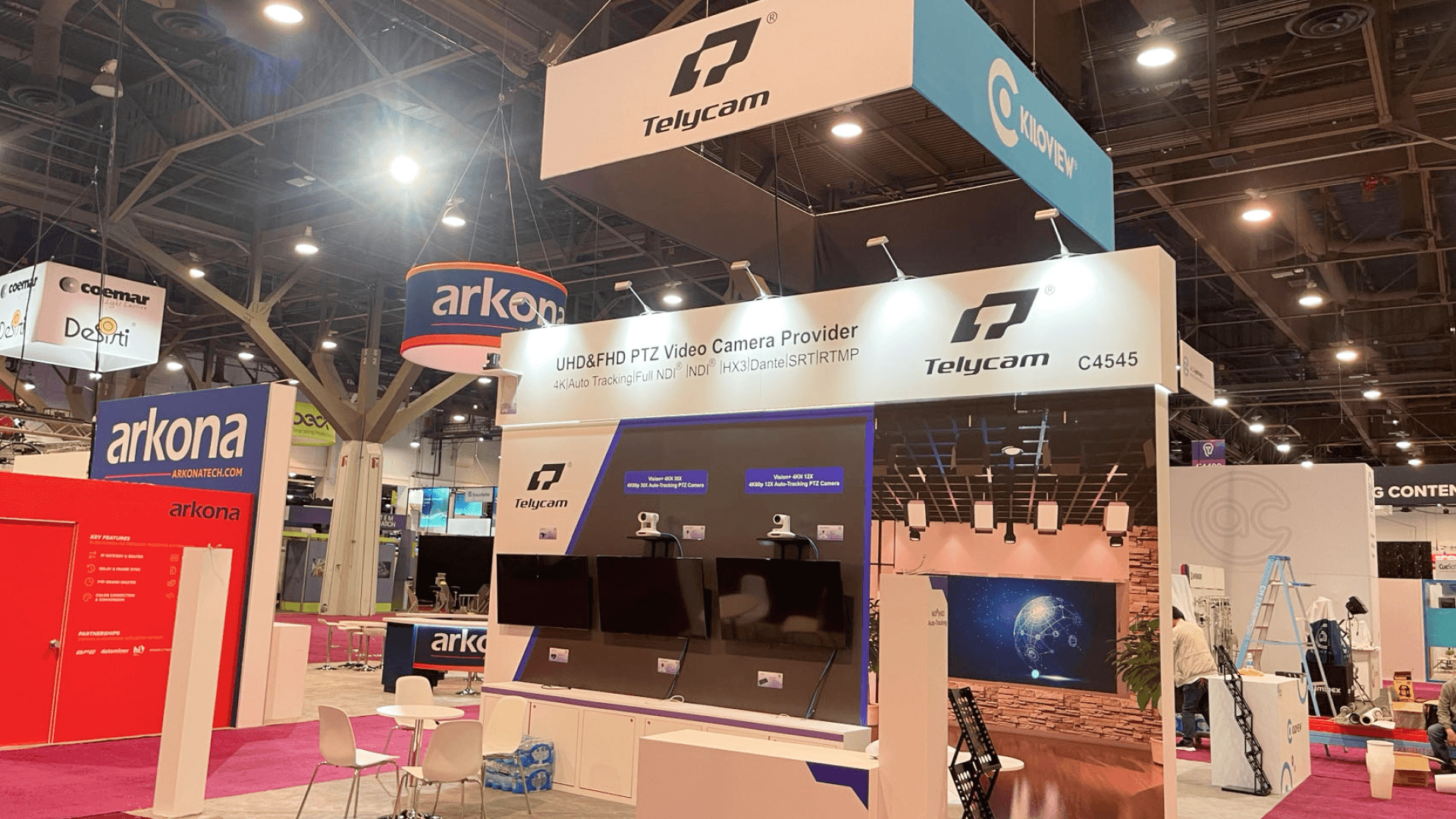 Kiloview NAB Show 2023 20x20 broadcast booth at Las Vegas Convention Center with reception counter, IP video solution wall, hanging sign, and final show-floor setup