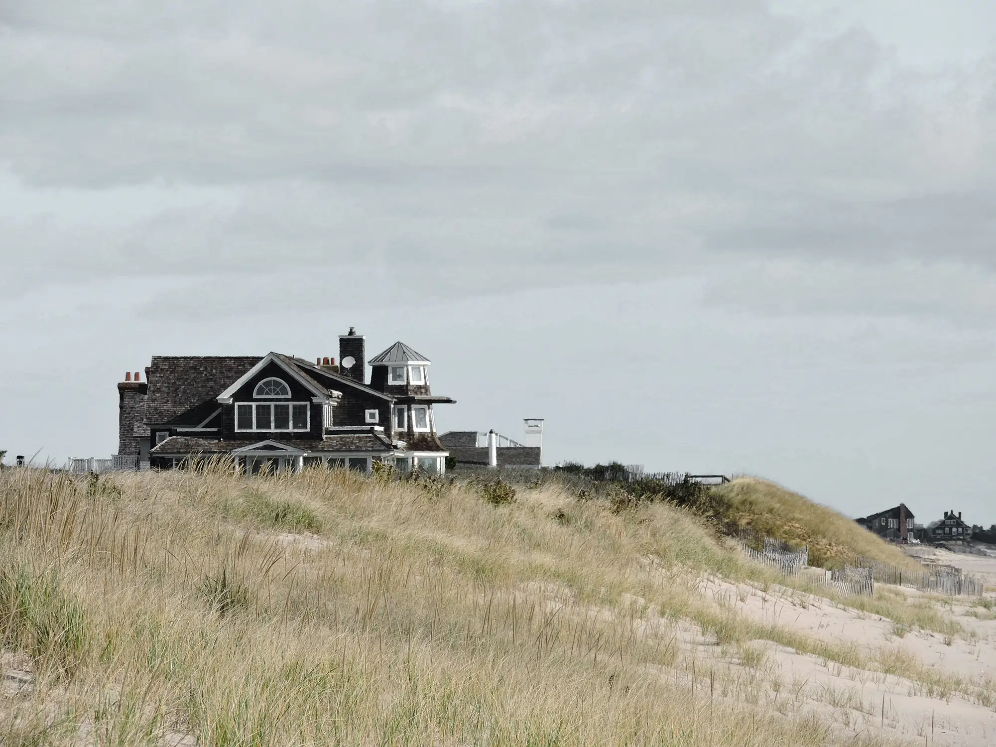 A traditional cedar shingled house on the beach in the Hamptons represented by a Hamptons NY luxury real estate brokerage