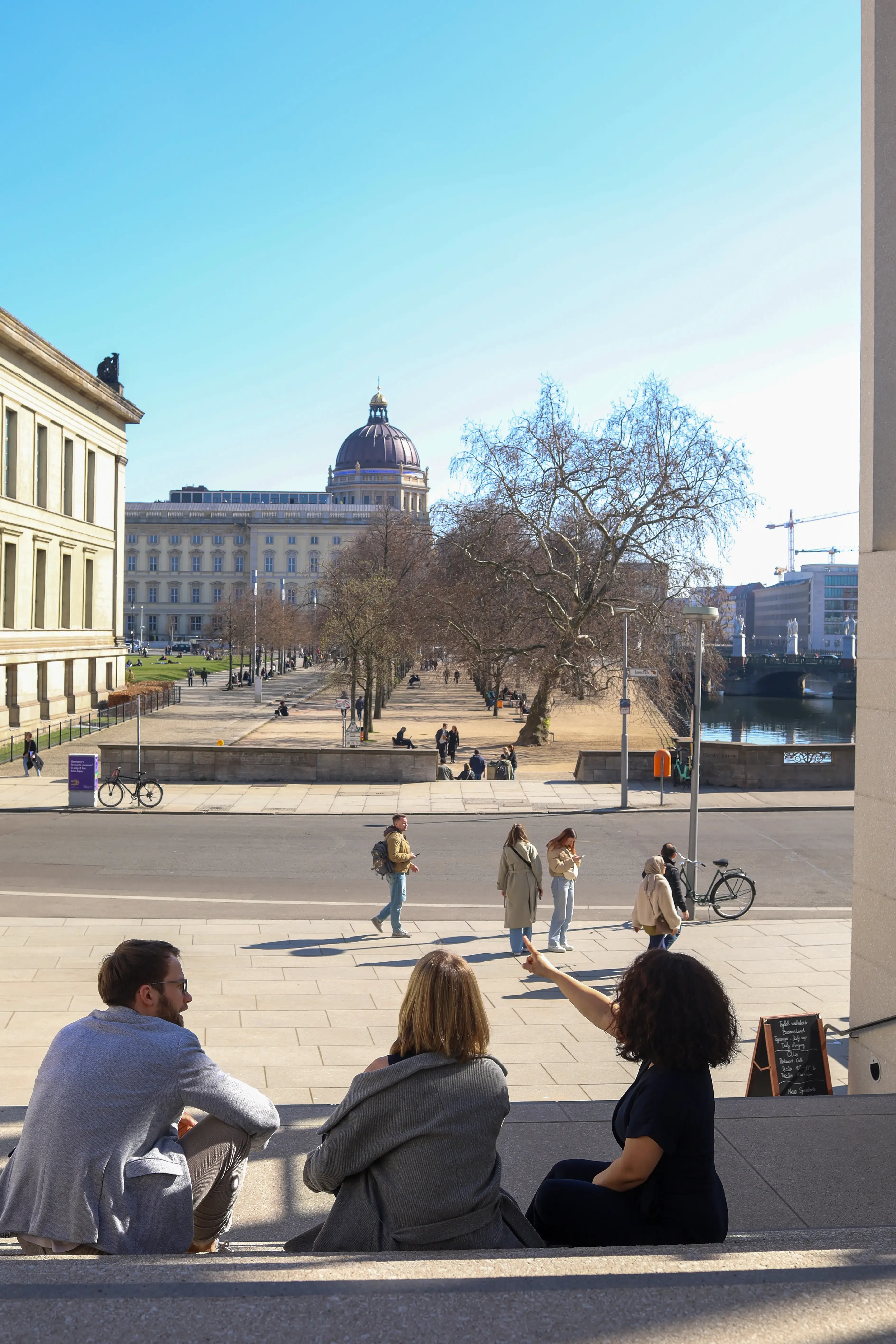Jenia and professionals overlooking a German city plaza, symbolizing career vision and job market exploration.