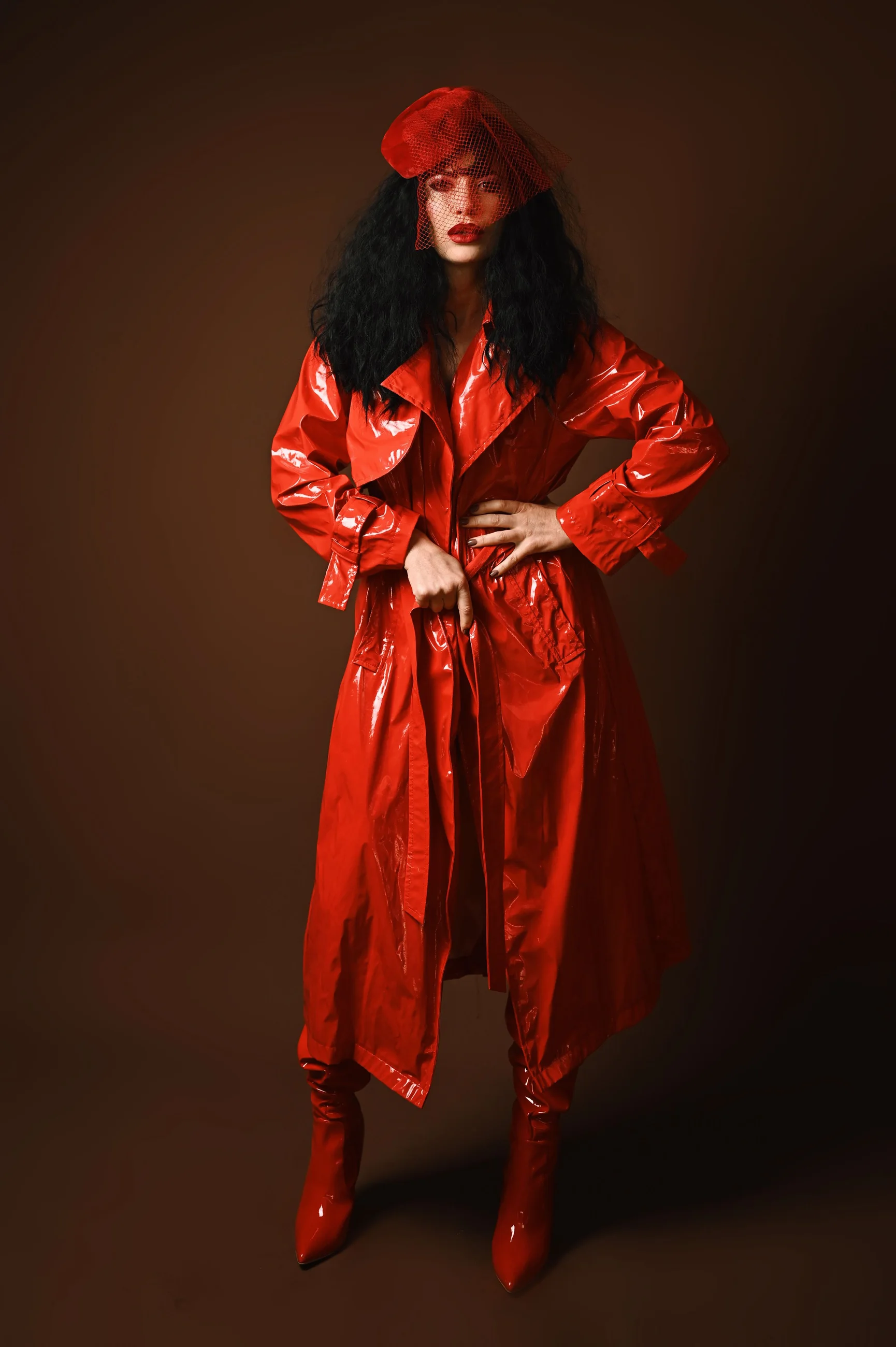 Sienna Rhodes in a red patent trench and veiled beret