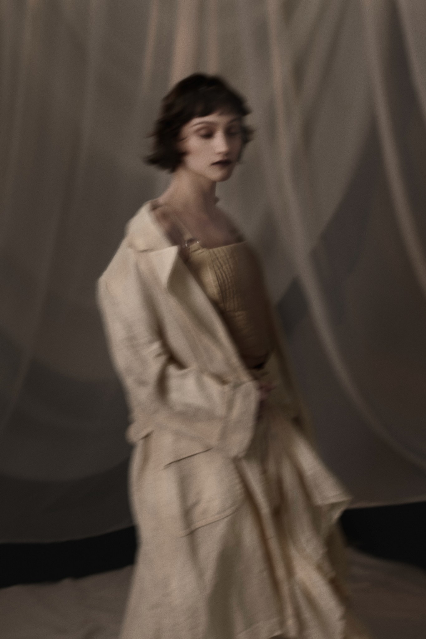 Fashion portrait of a young woman moving in a poetic and expressive way. Shot in the photo studio in New Orleans, by photographer Craig Mulcahy. 