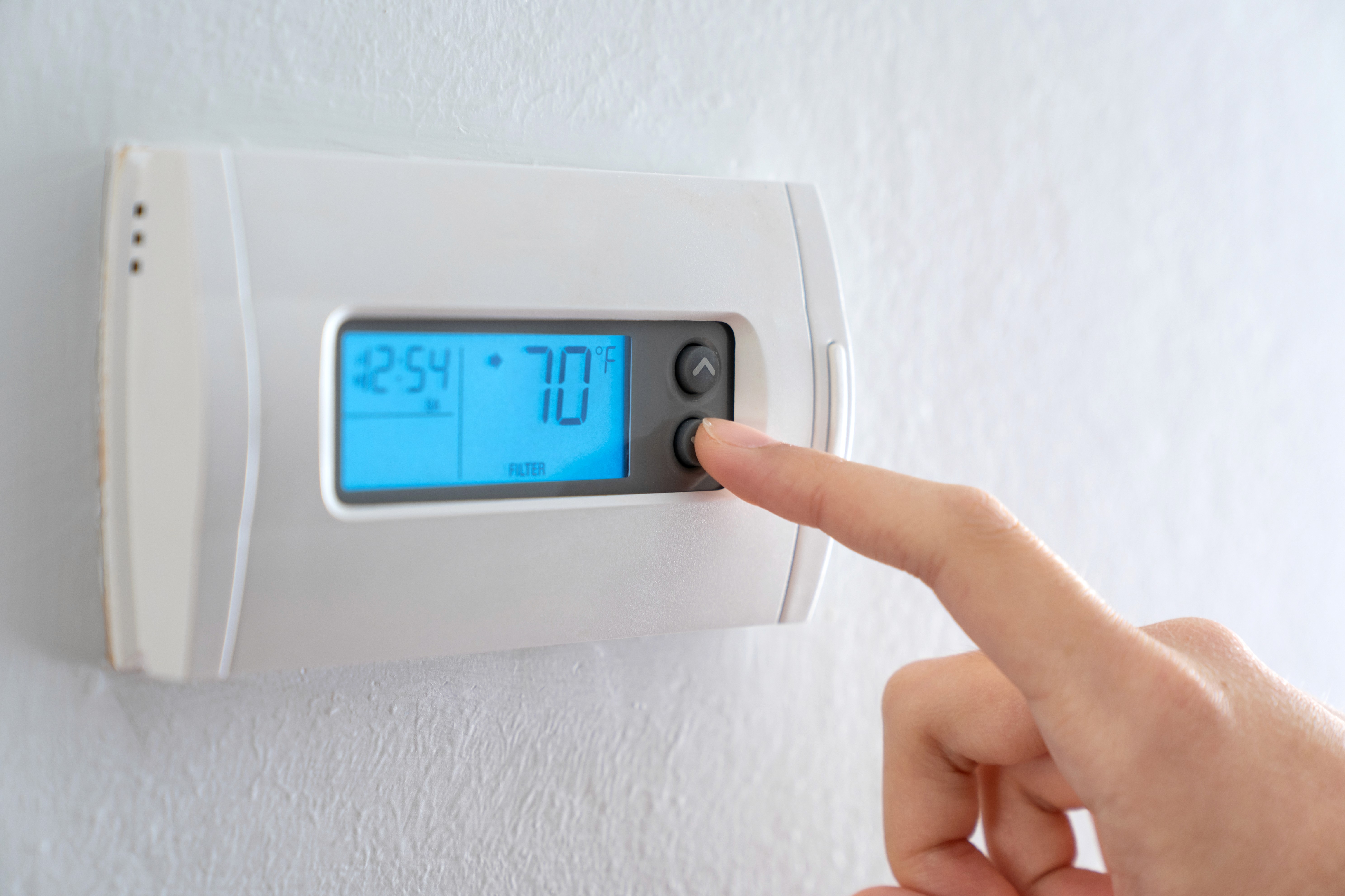 gray Nest thermostat displaying at 63
