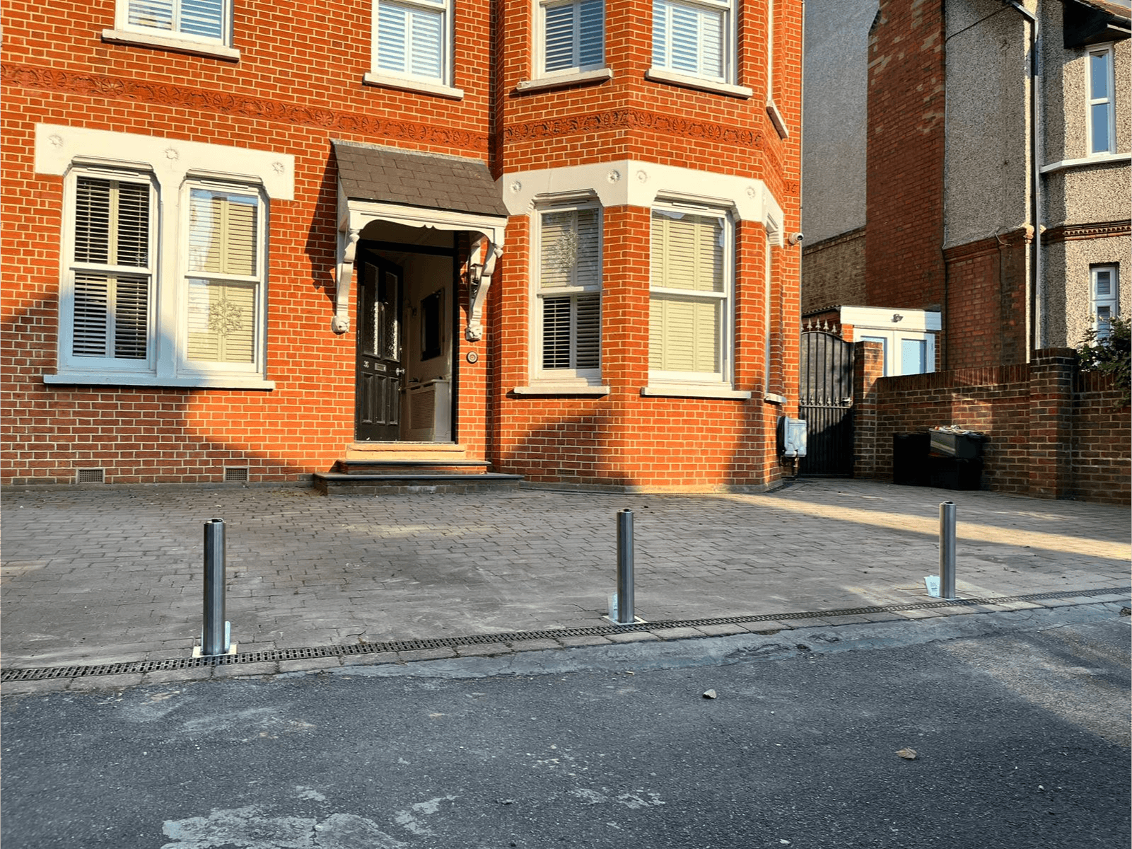 Driveway security posts in front of London home