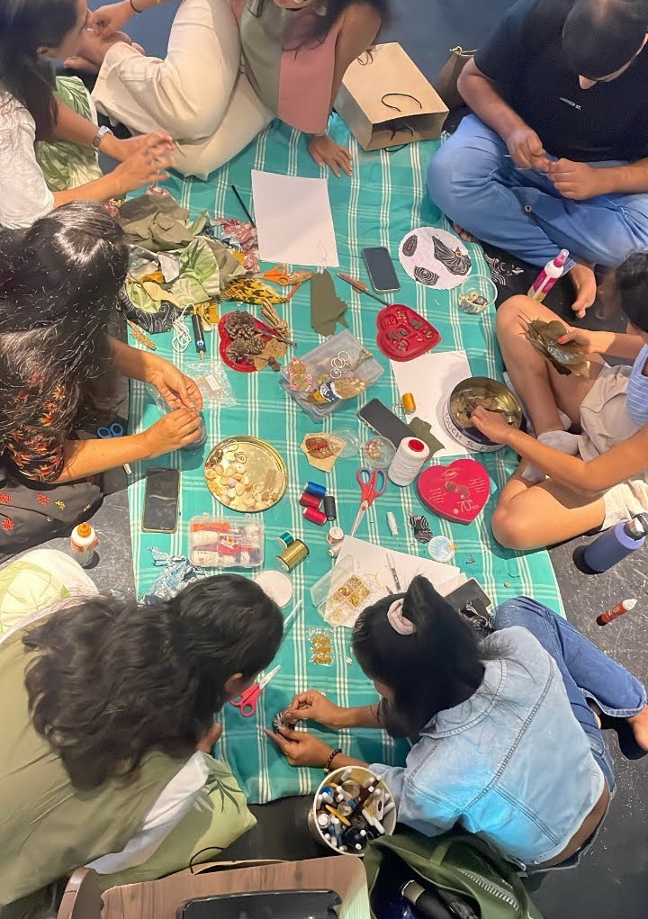 a group of women standing on top of a sandy beach
