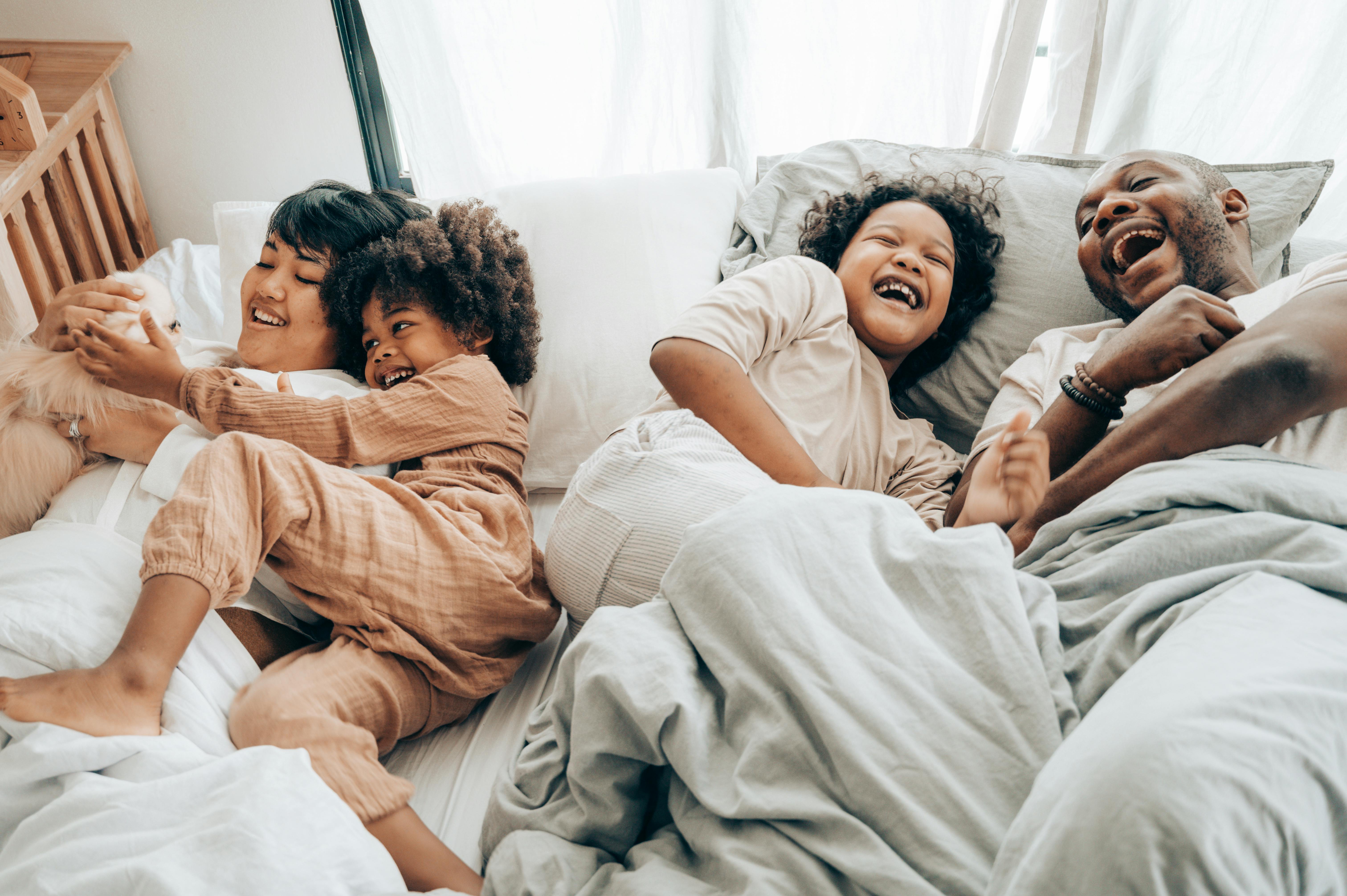 kids lying on a glass land and smiling