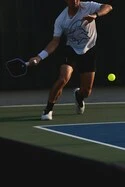 Man playing pickleball on a court