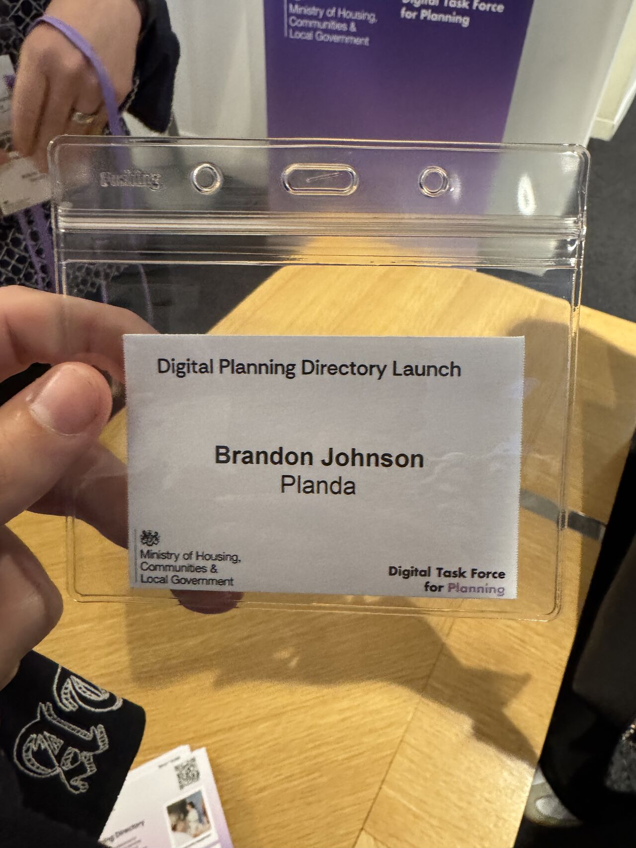 A close-up of a name badge for Brandon Johnson from Planda at the Digital Planning Directory Launch, featuring the Ministry of Housing, Communities & Local Government logo