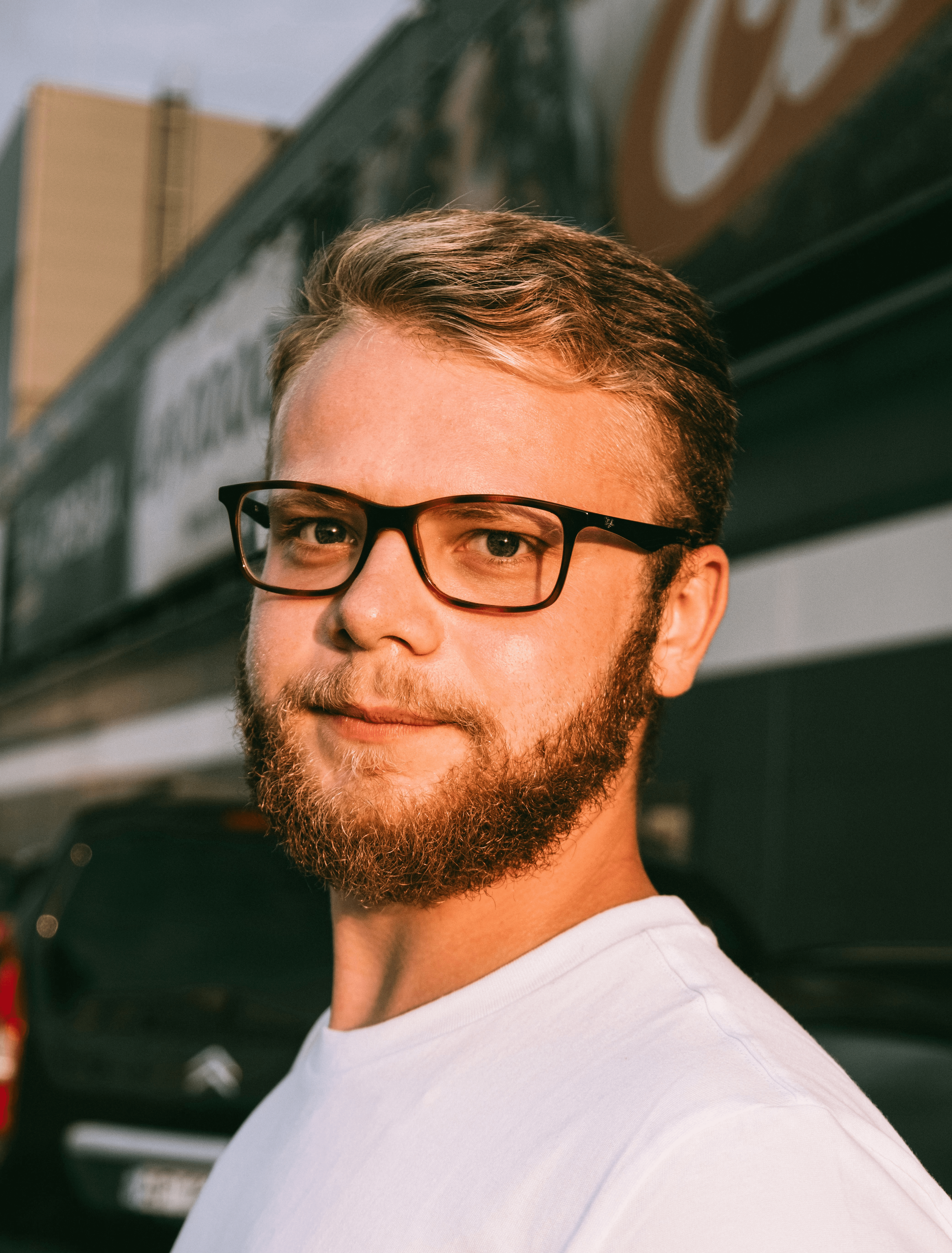 man in white crew neck shirt wearing black framed eyeglasses