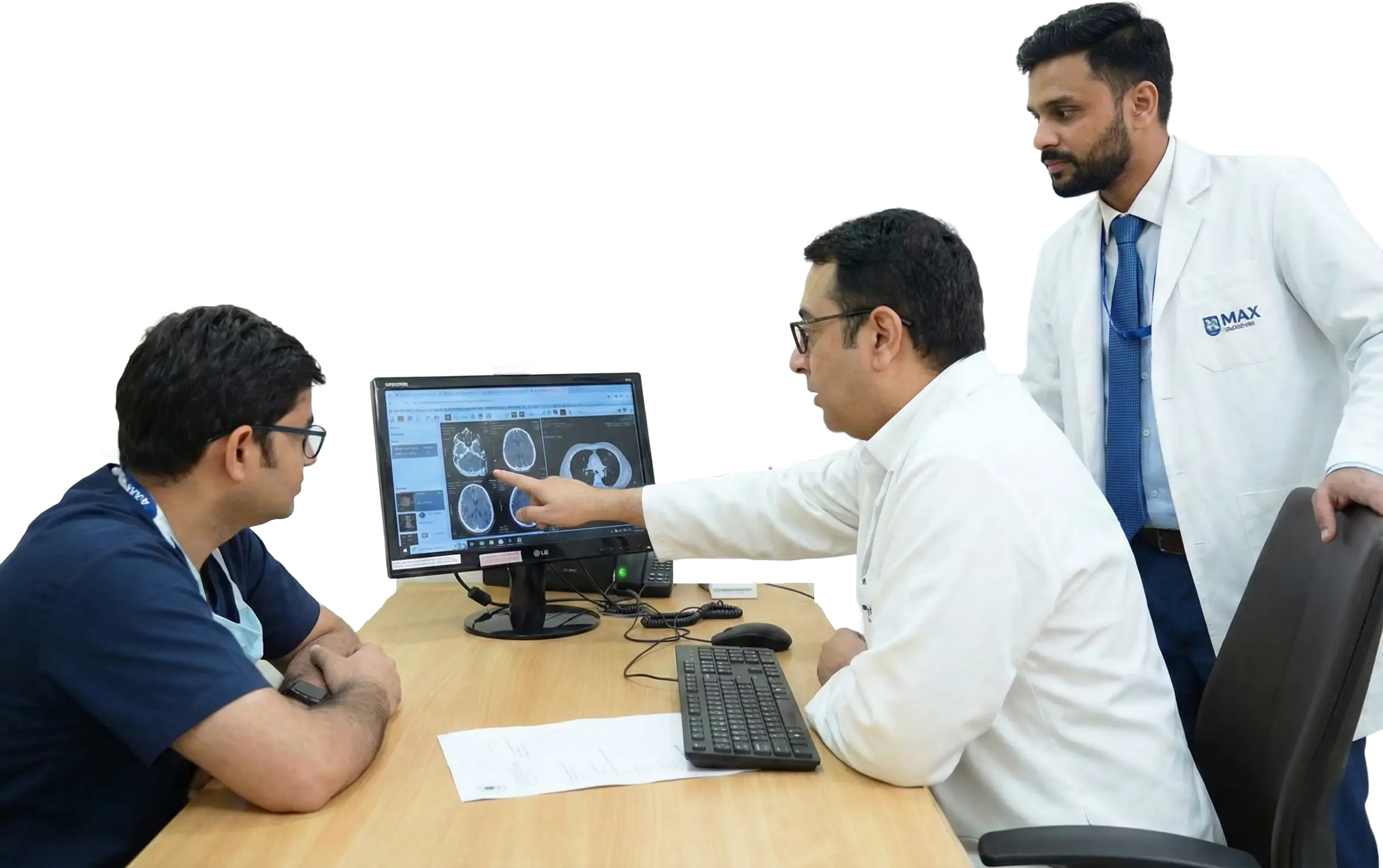 Dr. Tushar Aditya Narain reviewing a patient's diagnostic scan on a monitor with his medical team to coordinate surgical planning and recovery logistics.