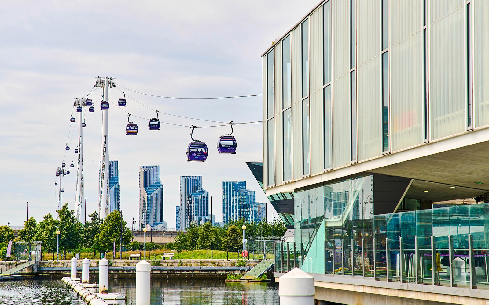 IFS Cloud Cable Car over River Thames in London with city skyline in background.