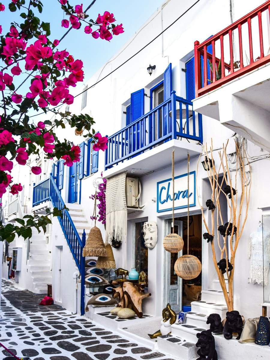 three brown wooden boat on blue lake water taken at daytime