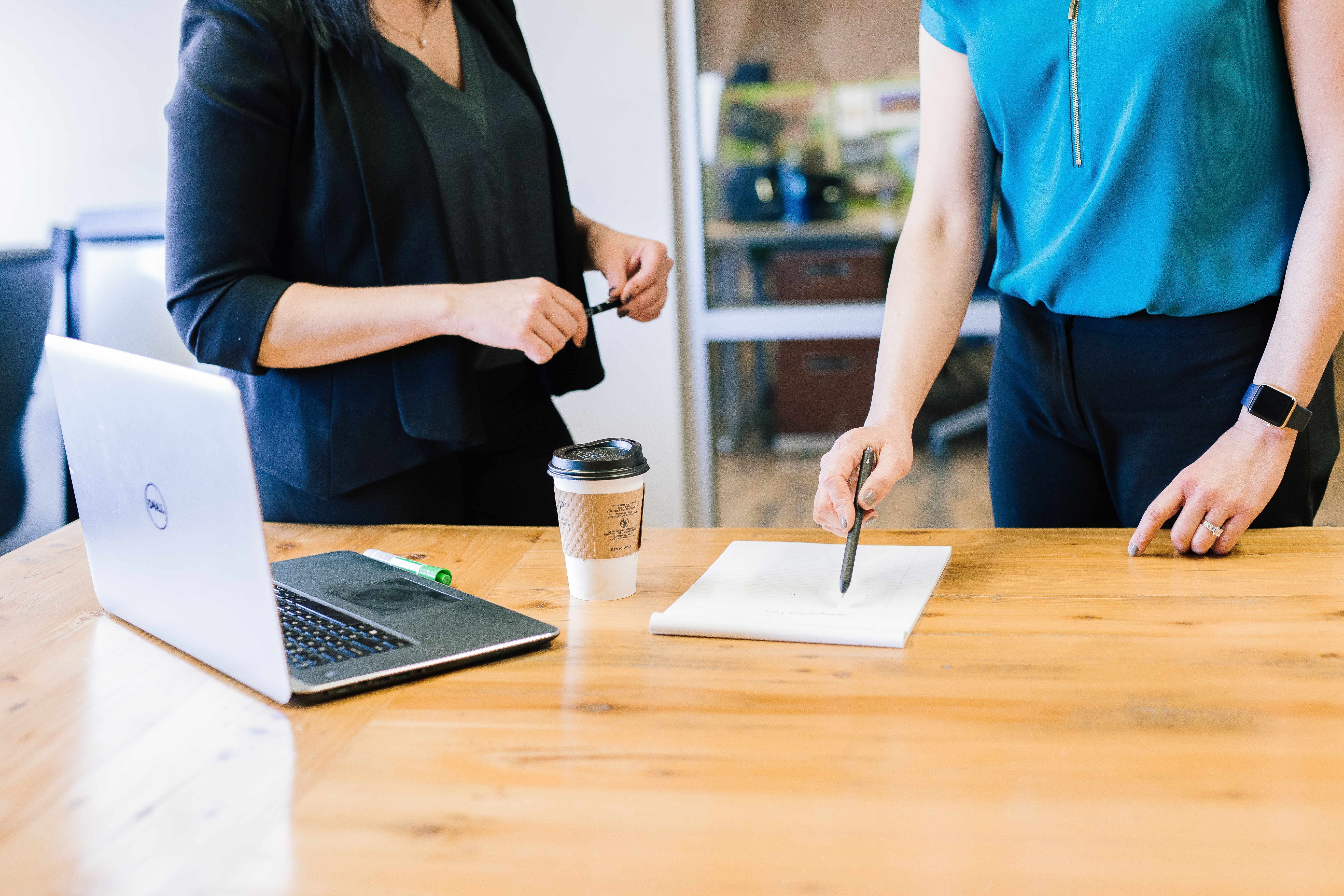 woman showing coworker the benefits of analysis - how to do sentiment analysis