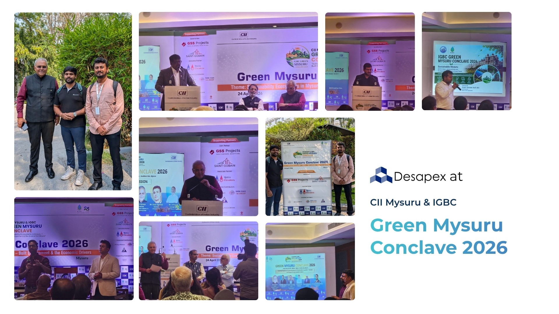 A man stands while two people sit at a table in an office setting, smiling and engaged in conversation. The mood is friendly and collaborative.