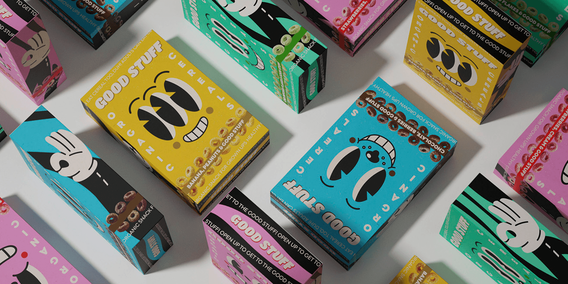 Good Stuff Brand World – colorful folding boxes with illustrated eye and mouth characters in yellow, turquoise, and pink.