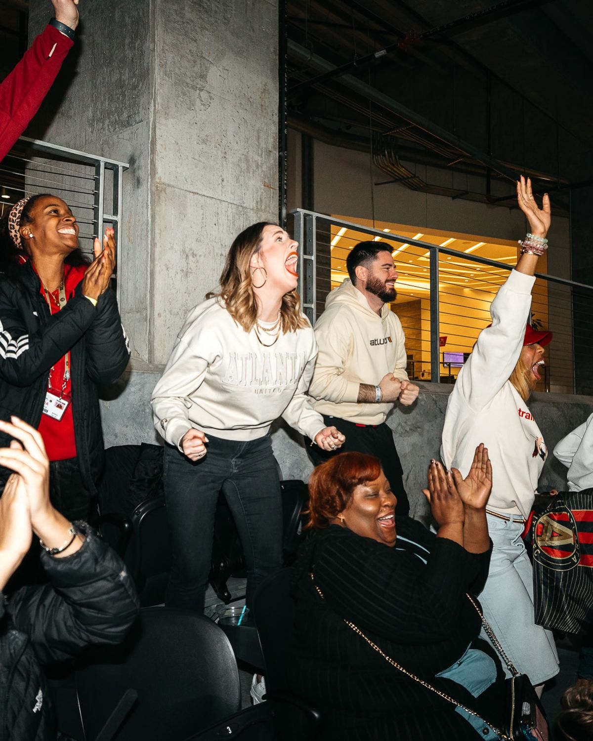 two people sitting at a table with laptops