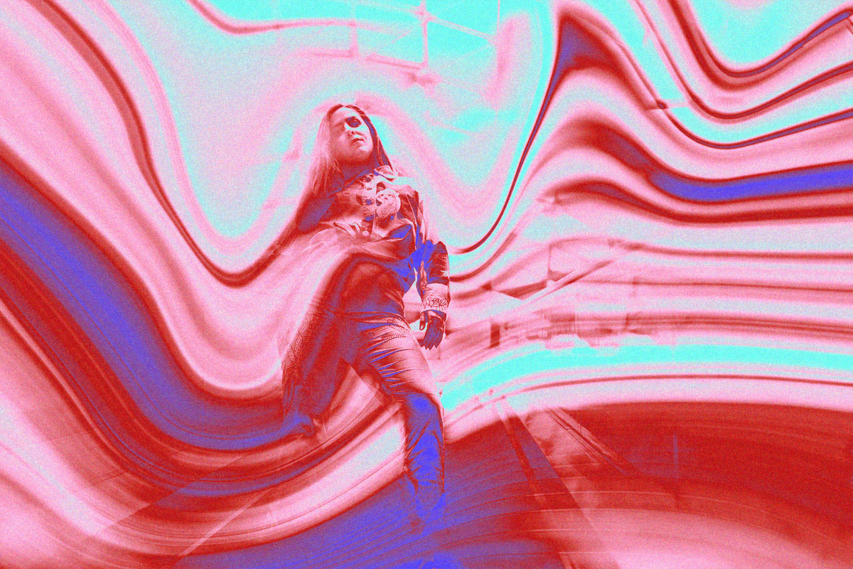 a woman stands in the center of the image, motion blur and liquify effects making the image unique and interesting also there is a gradient effect added with bright purple, blue and red colours. 