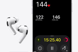 Wireless earbuds with built-in health sensors resting beside a charging case
