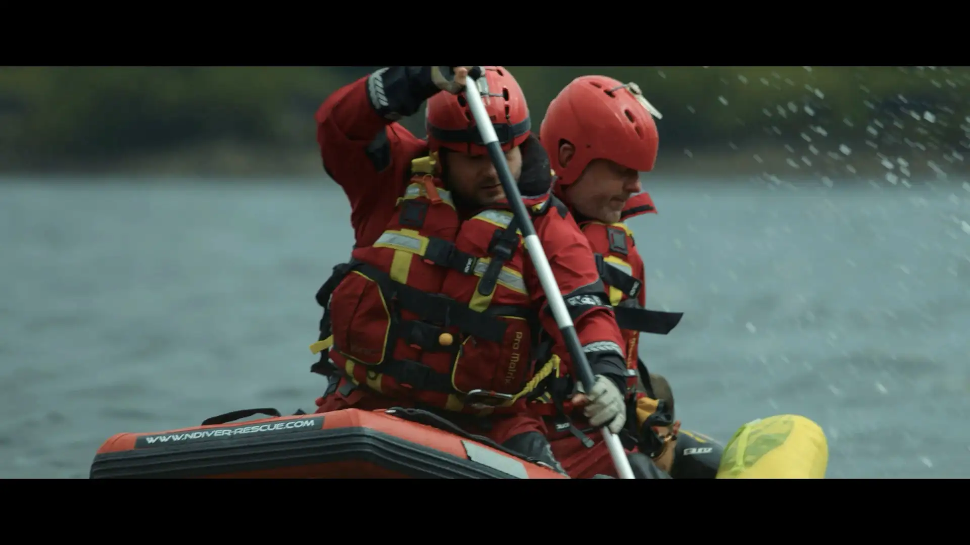 Group of presenters speaking on camera during a Microsoft live broadcast, filmed against branded event graphics.