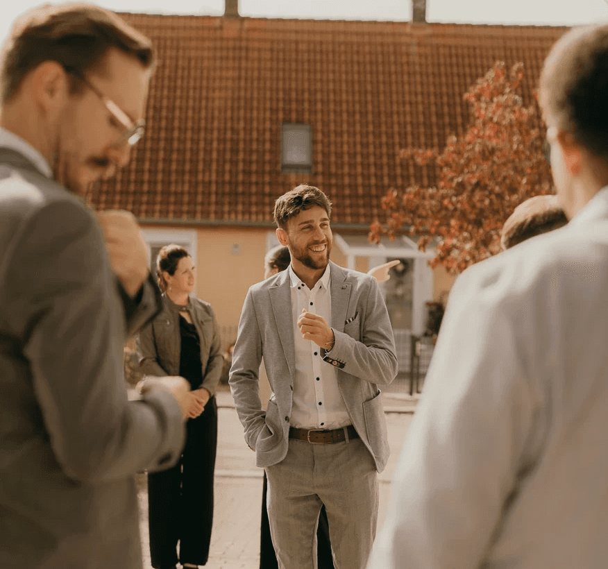 Portrait of a person in a pink sweater against a light background