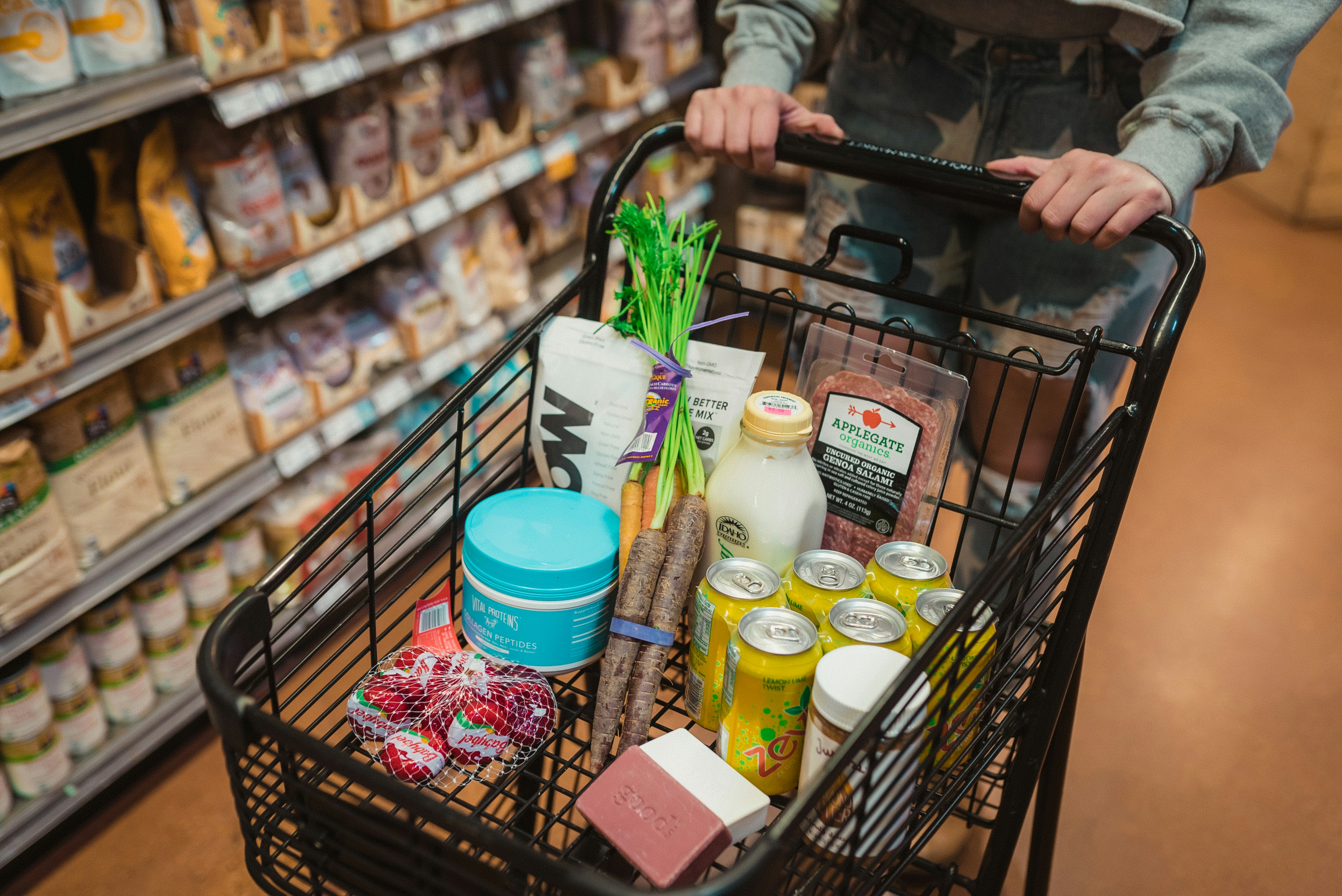a spokane runner pushing a shopping cart full of food