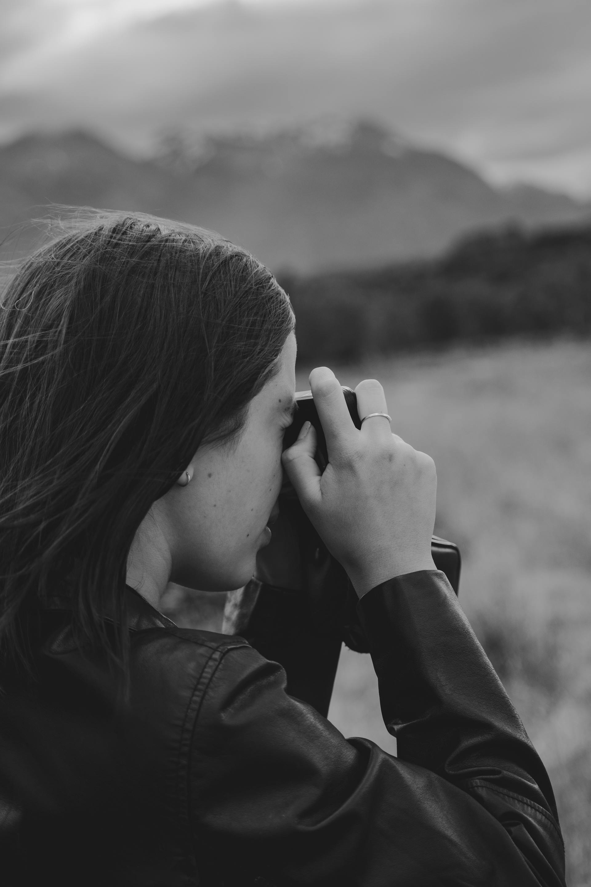 A girl taking pictures with a camera, black and white style