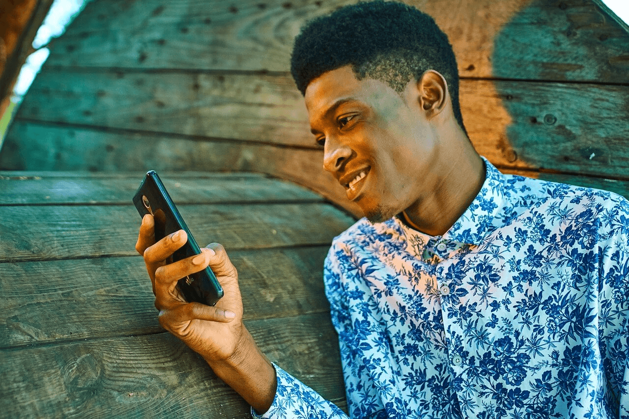 Man holding phone and smiling