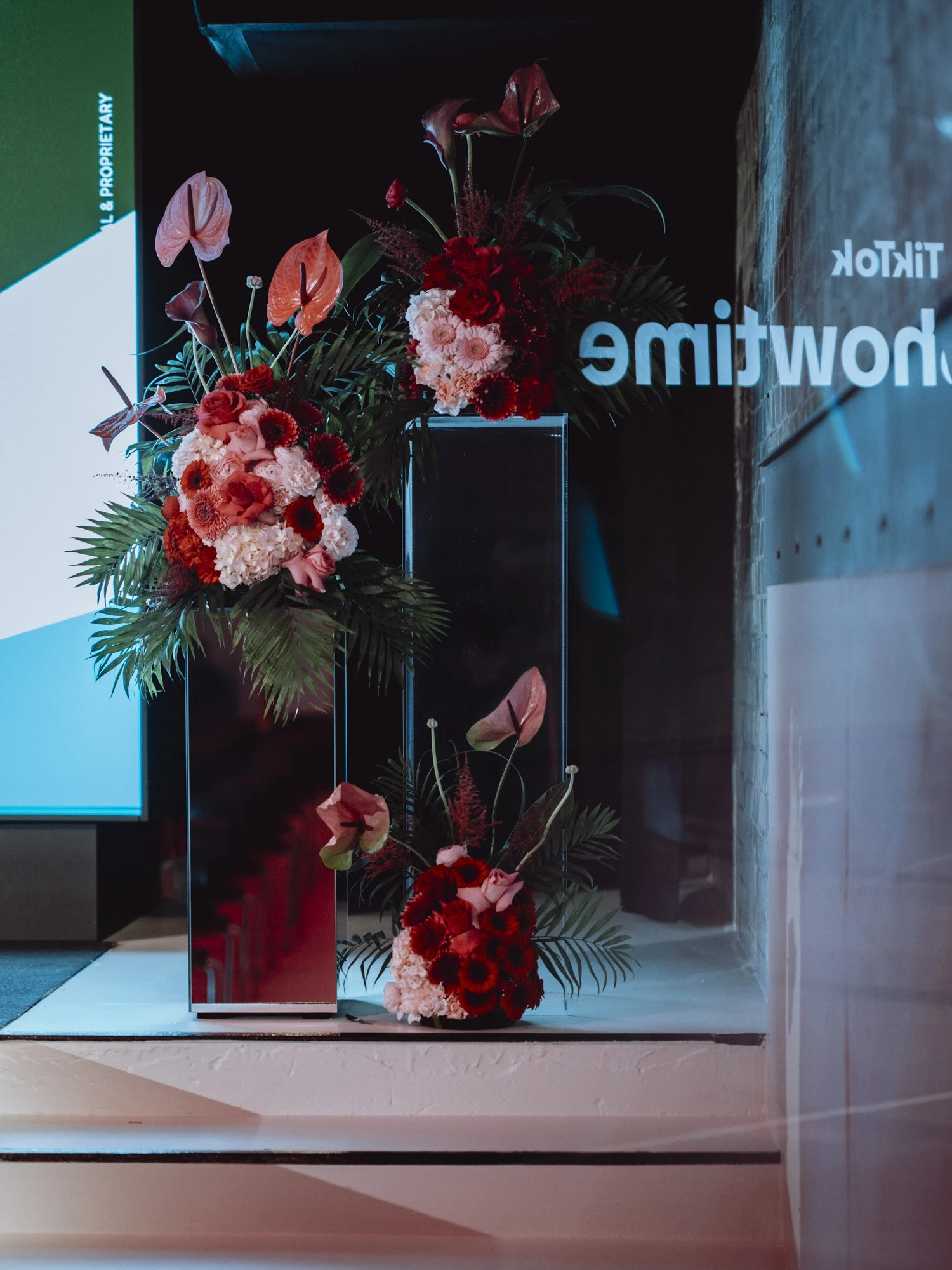 Red and pink flower arrangements on mirrored pillars beside the TikTok Showtime stage.