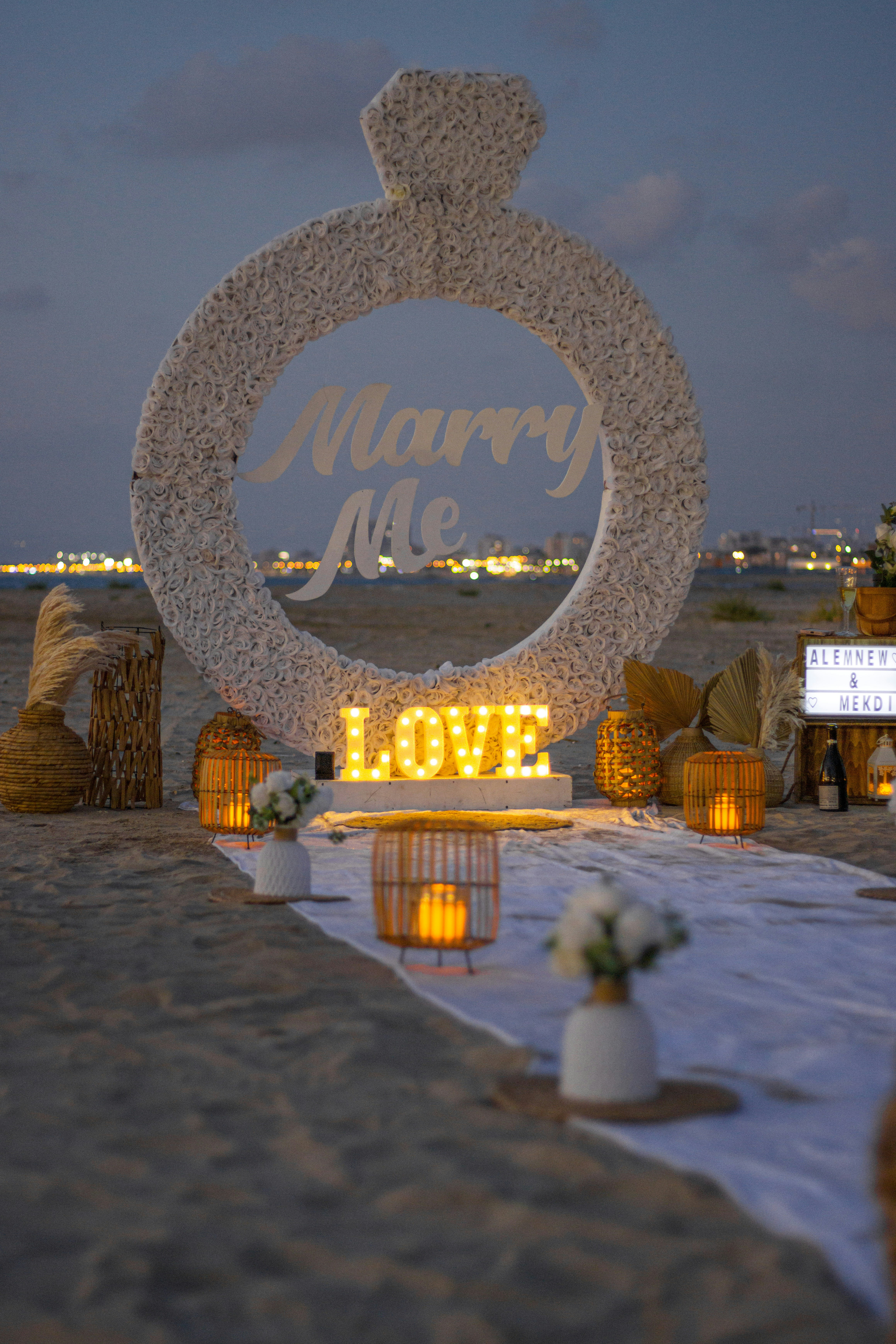a sign that says marry me on the beach