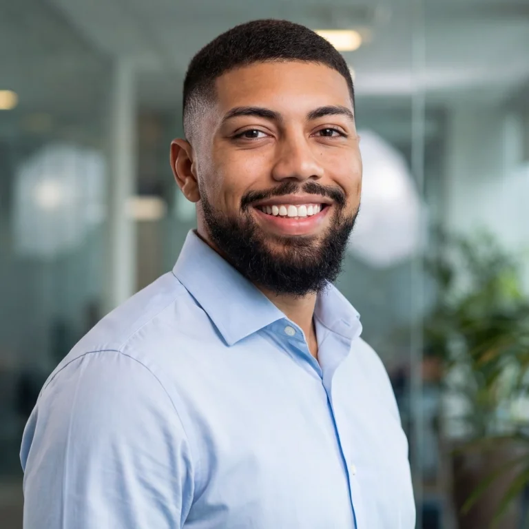 a man standing in front of a purple wall
