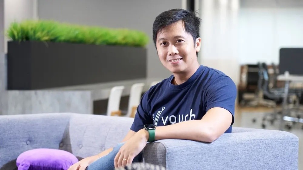 A mountain range is reflected in the still water of a lake