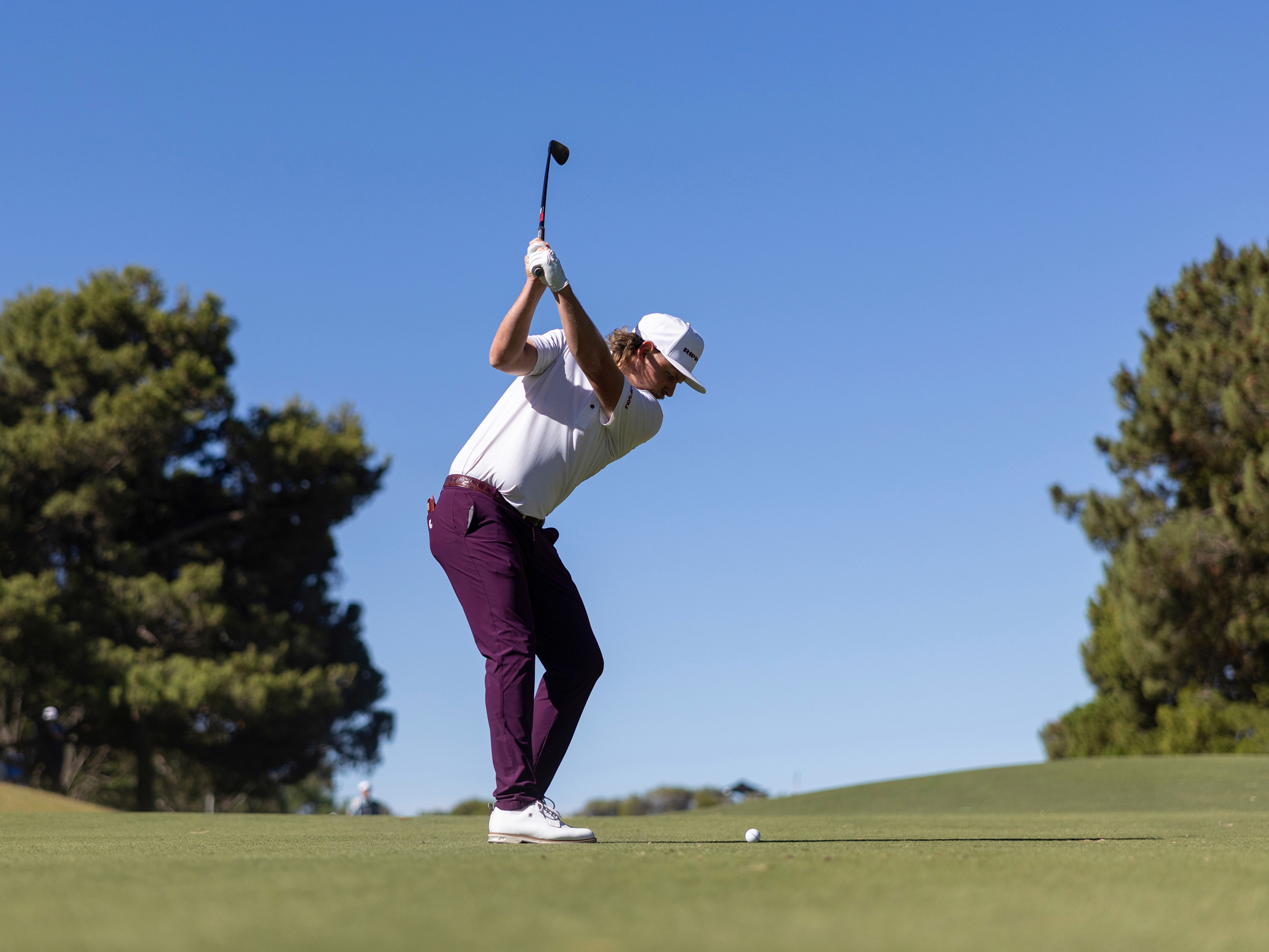 Editorial photograph of a LIV Golf player during competition, representing the real-time media coverage supported by the platform.